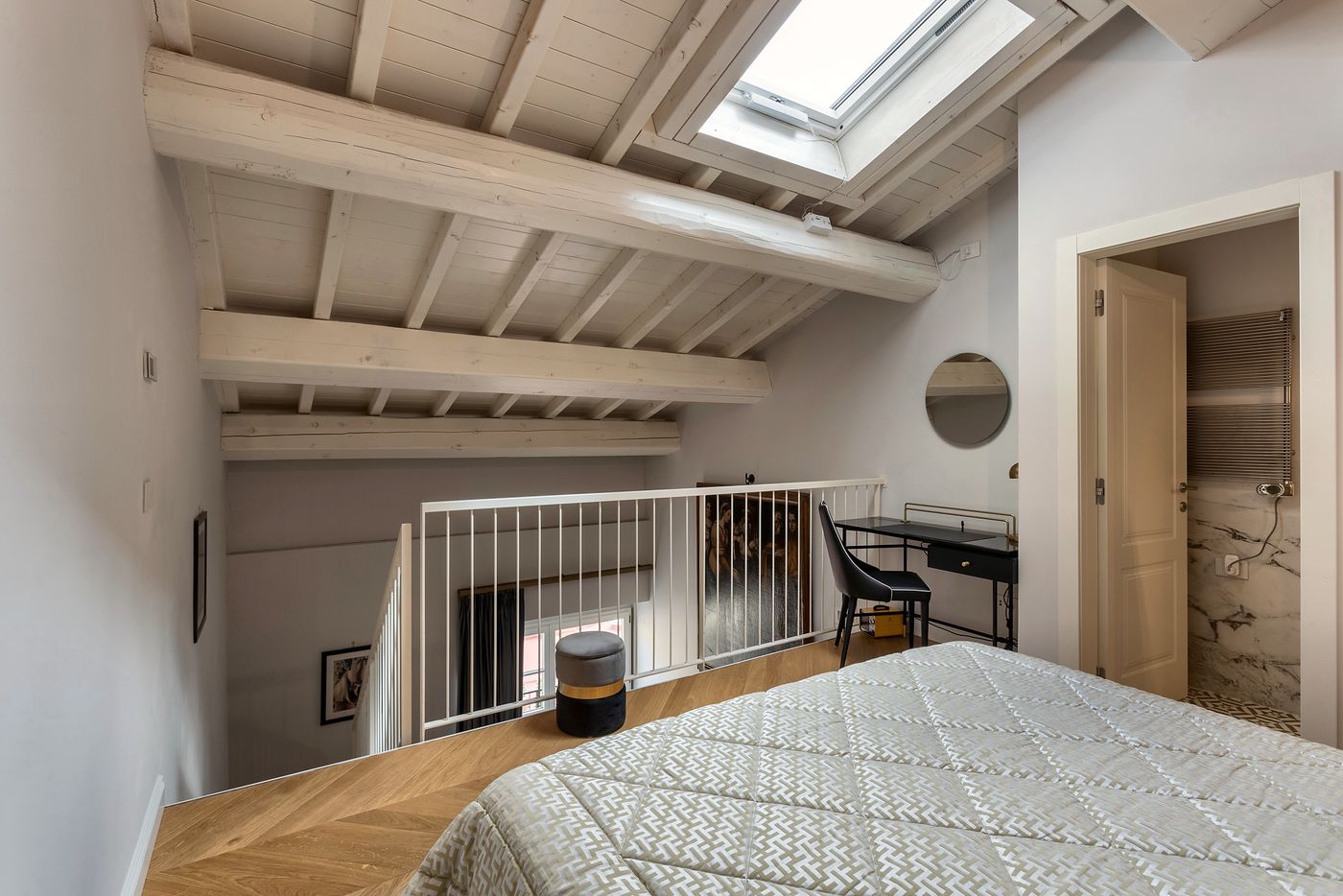 Mezzanine bedroom under wooden beams